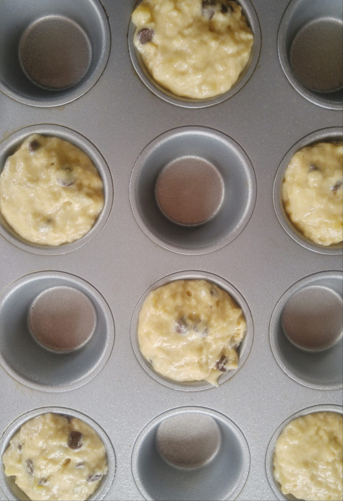 muffin pan with every other spot filled with muffin batter