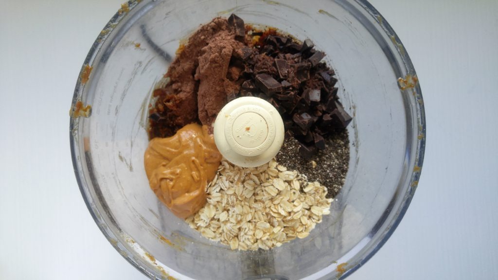 oats, peanut butter, chia seeds, chocolate chunks, cacao in a food processor