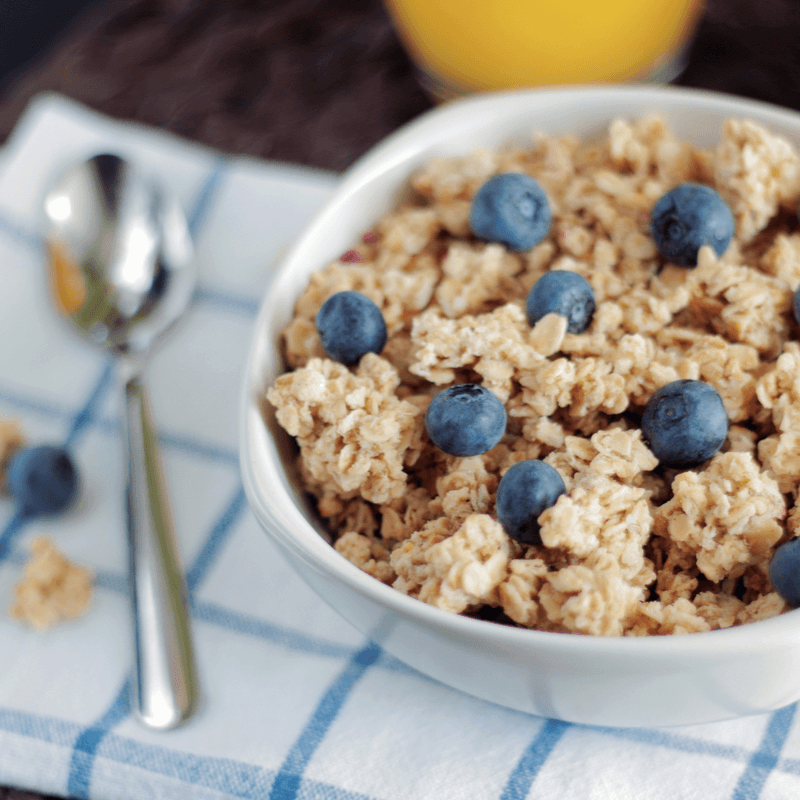 close up of a bowl of oatmeal with fresh blueberries on top