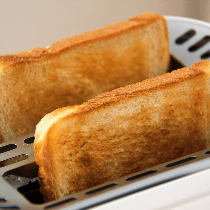 Close up of toast popping out of a toaster.