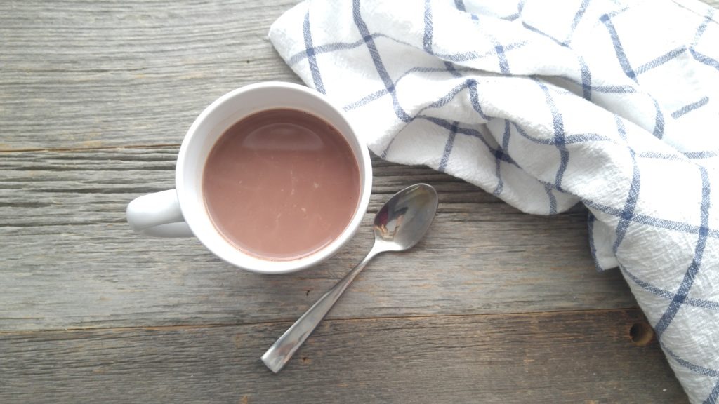 simple mug of hot chocolate on a rustic wooden table.