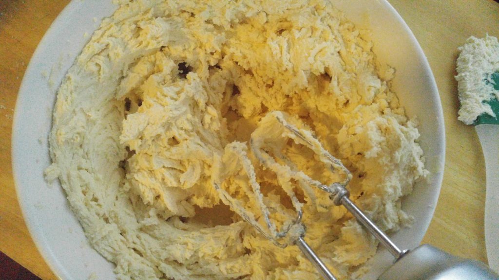 Mixed raw shortbread cookie batter in white ceramic bowl.