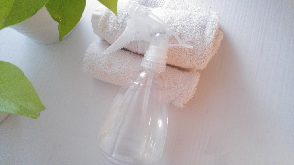 flat lay picture of a spray bottle and towels
