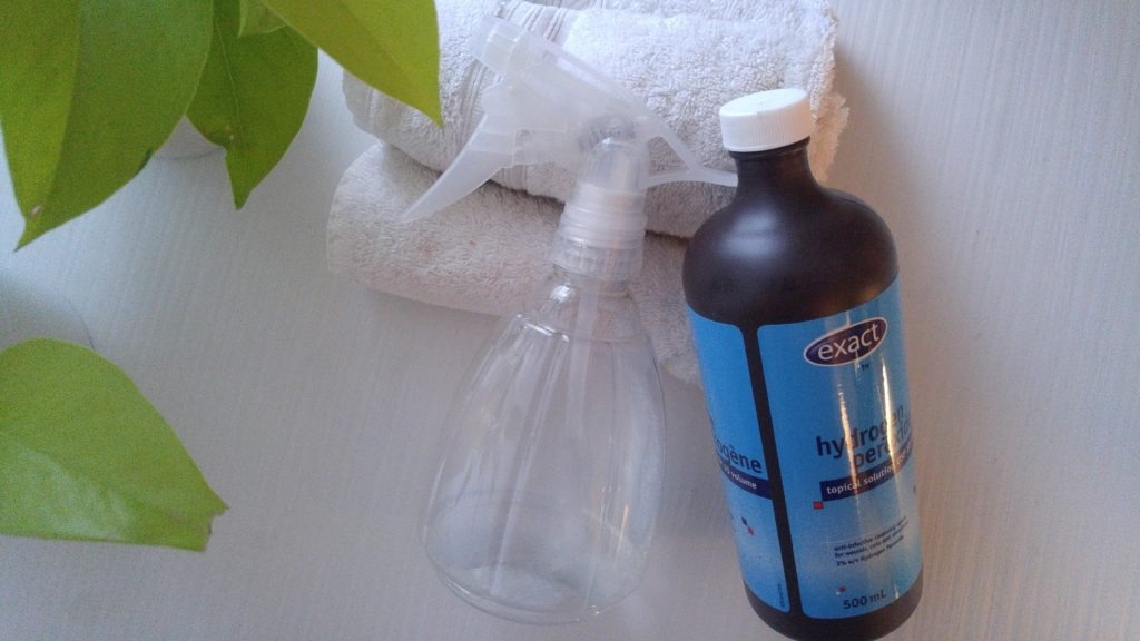 bottle of hydrogen peroxide and clear spray bottle