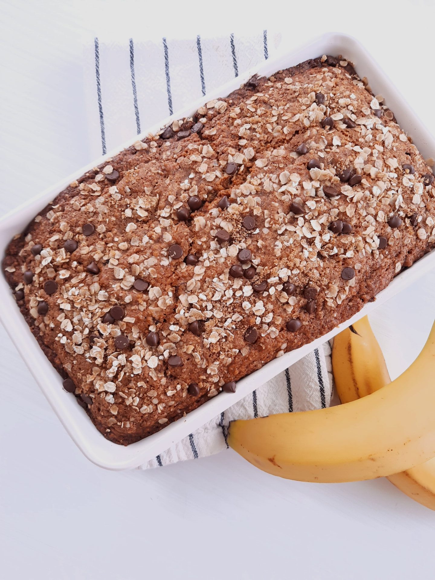 The best banana bread in pan on white counter