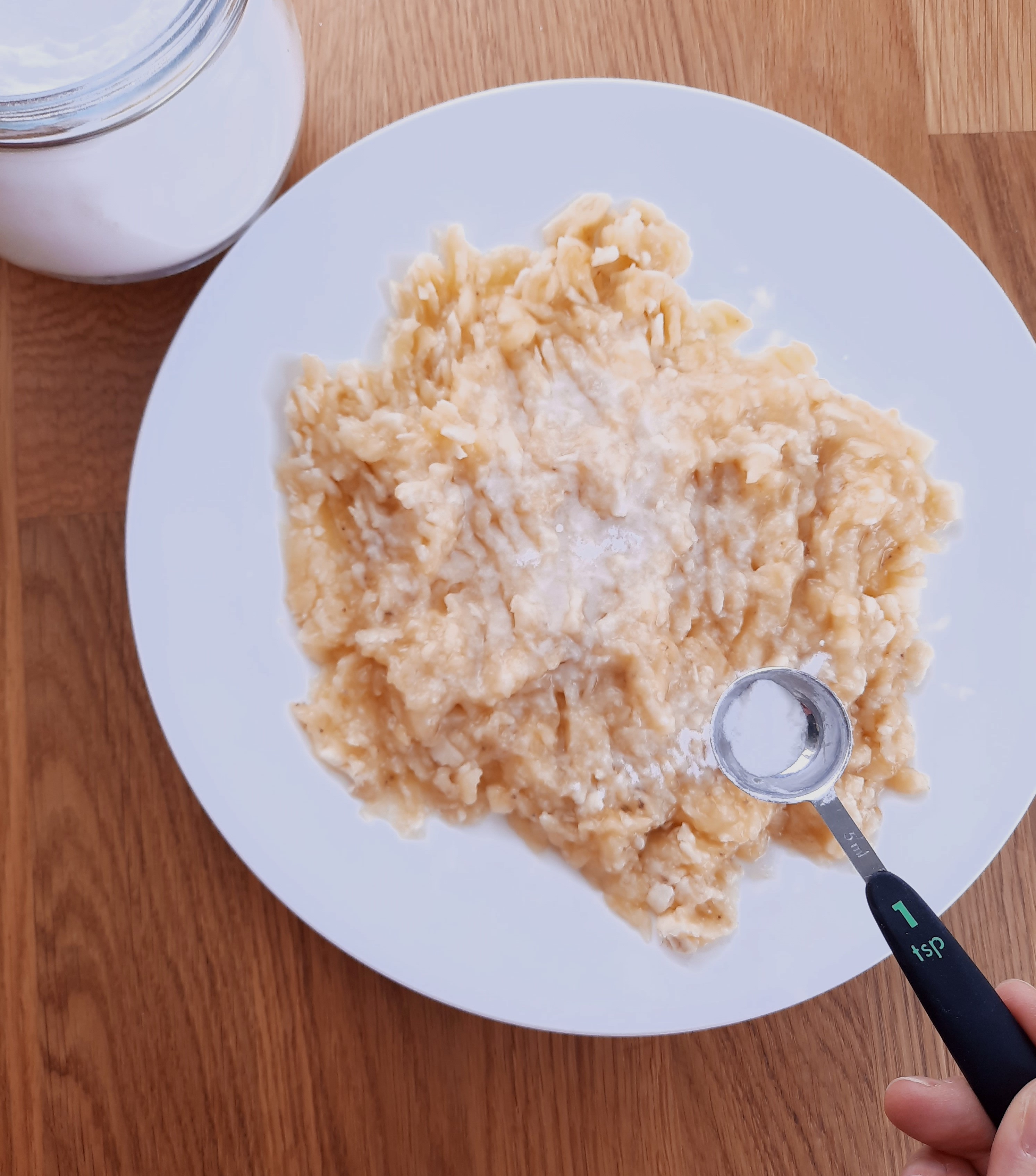 sprinkling baking soda on top of mashed bananas