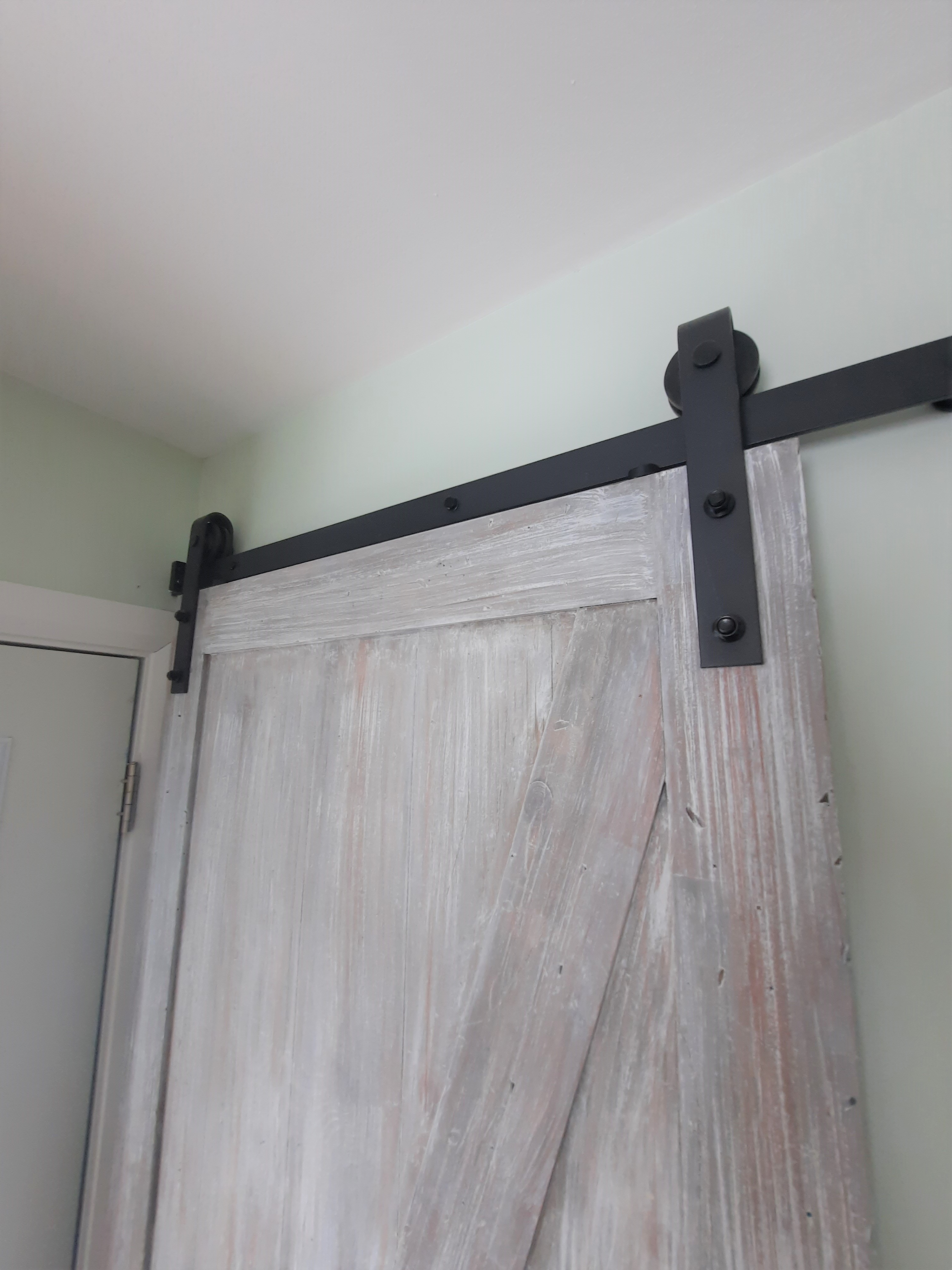 rustic barn door hung on black hardware