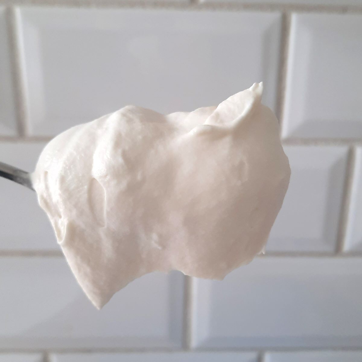 whipped cream piled high on a spoon