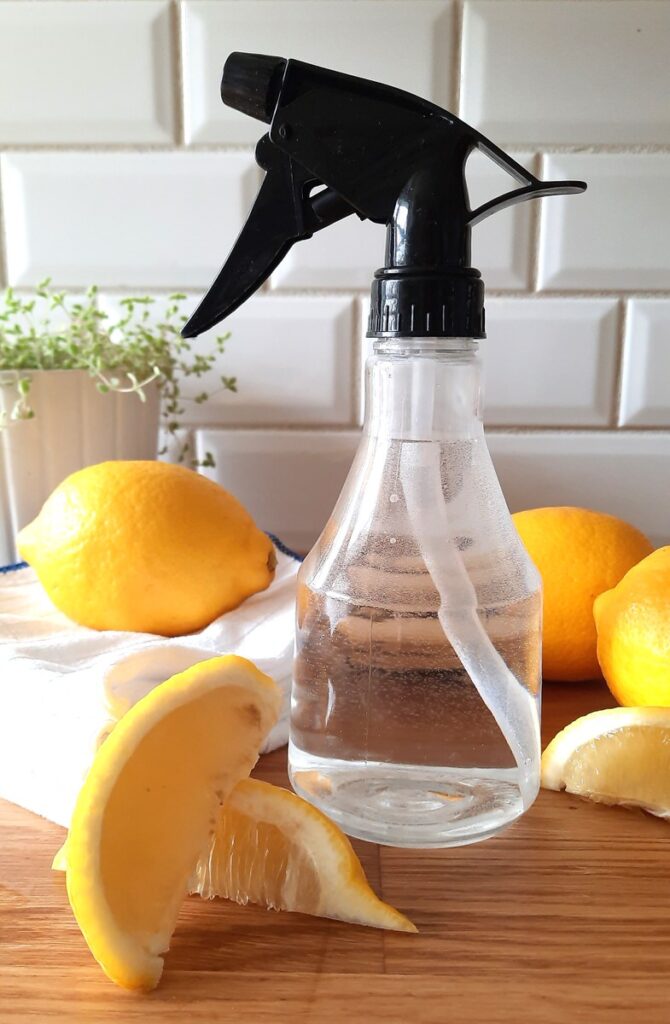 clear spray bottle with lemon all purpose cleaner inside