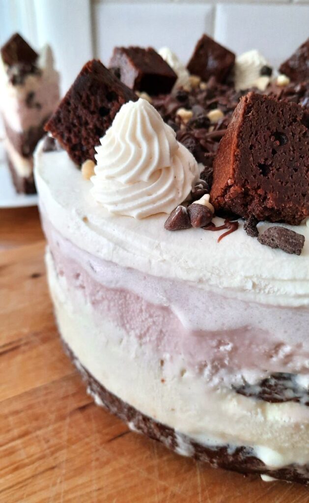 close up of brownie ice cream cake with a slice in the background