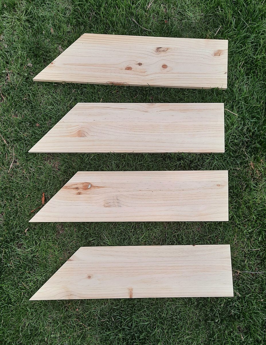 4 boards all cut on one side at a 45 degree angle lay on the grass