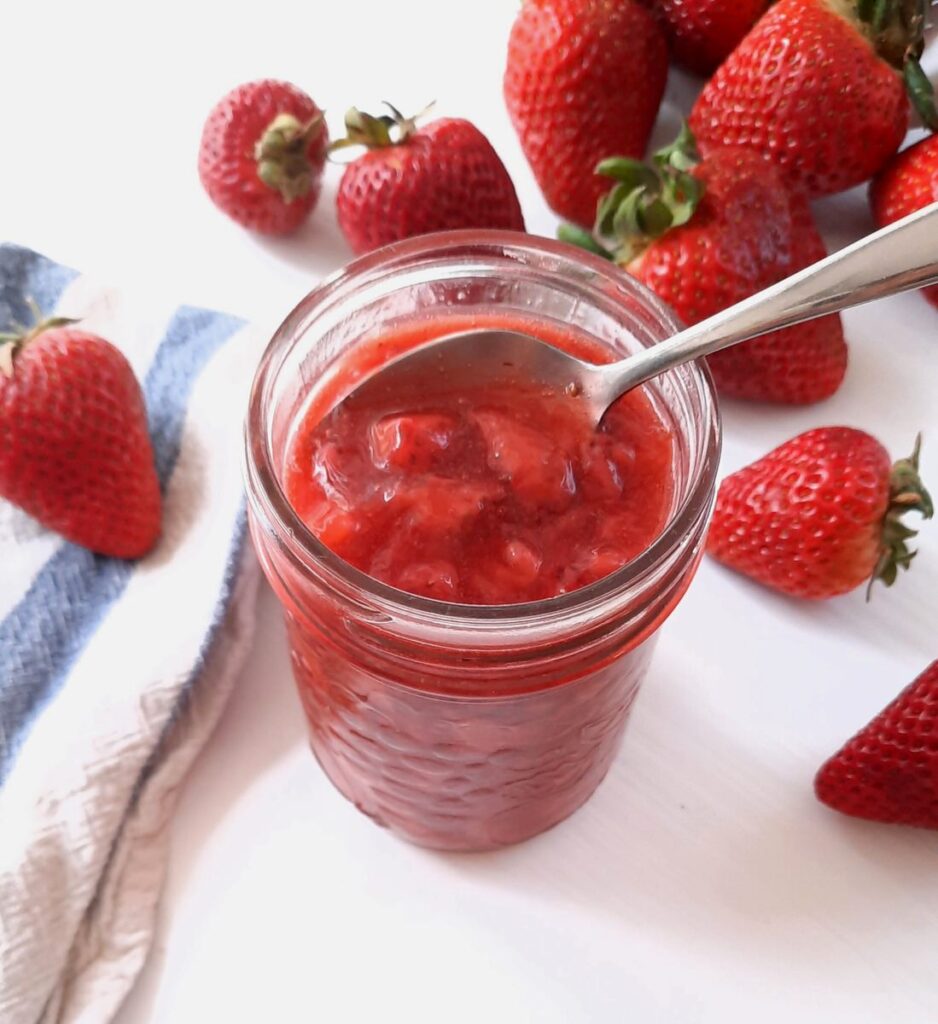 top shot of a mason jar full of simple strawberry sauce