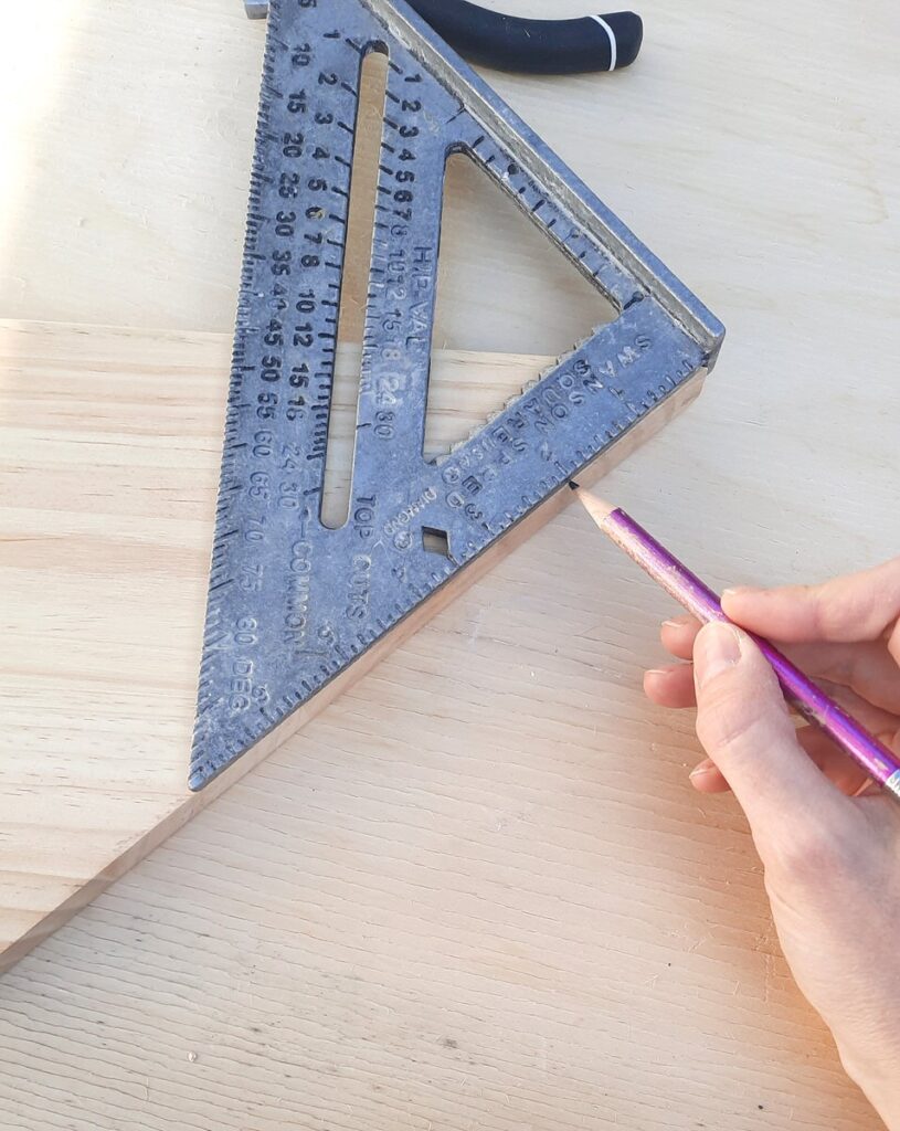 measuring 2 inches down the edge of a shelf board