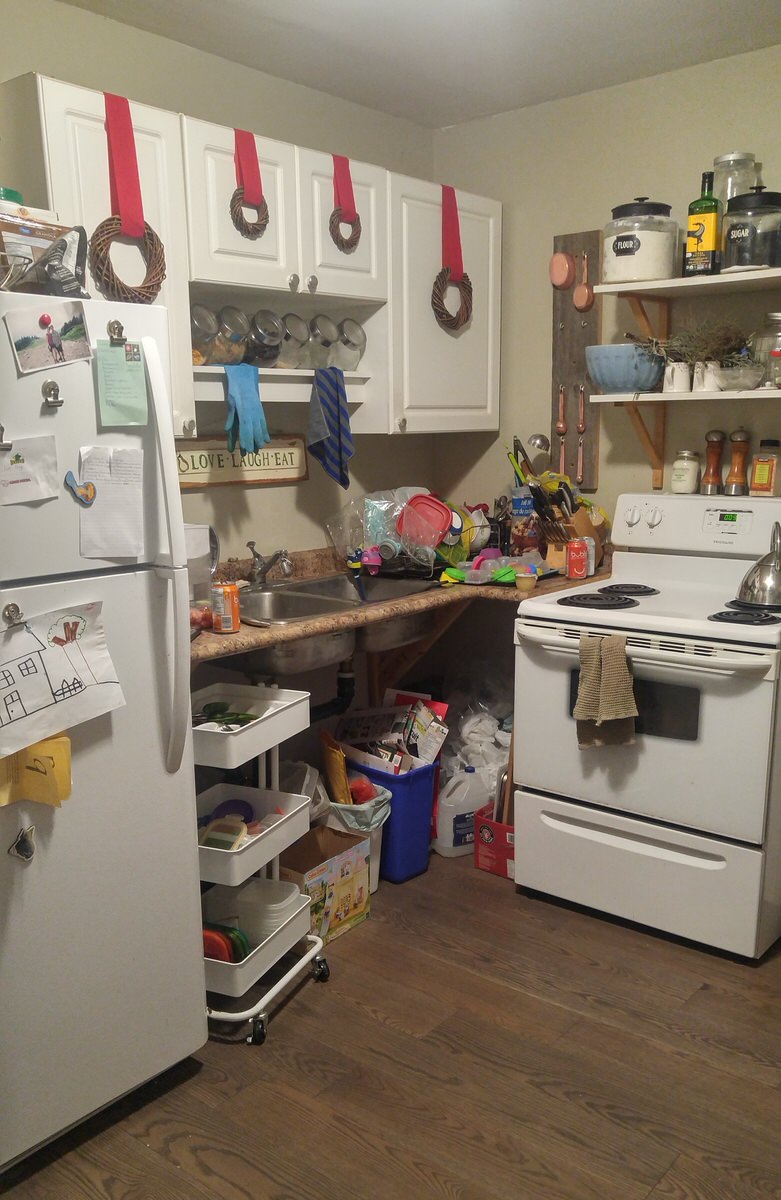 messy kitchen with no cabinets or storage