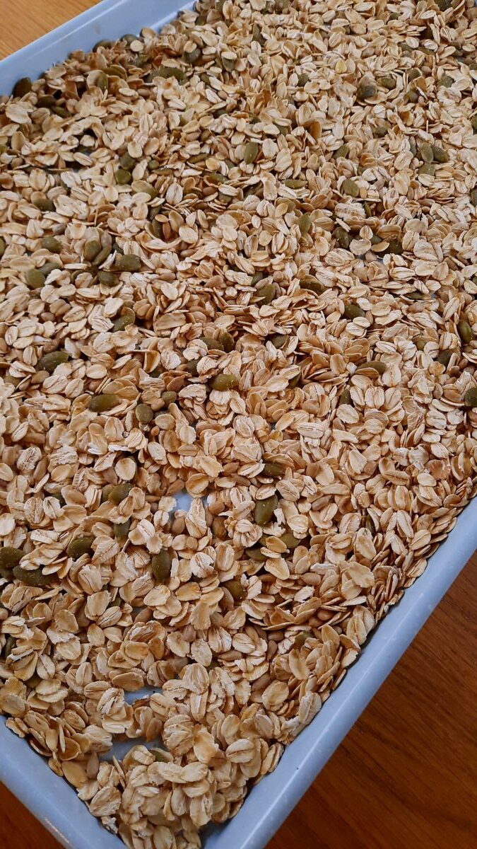 toasted oats and seeds on a baking sheet