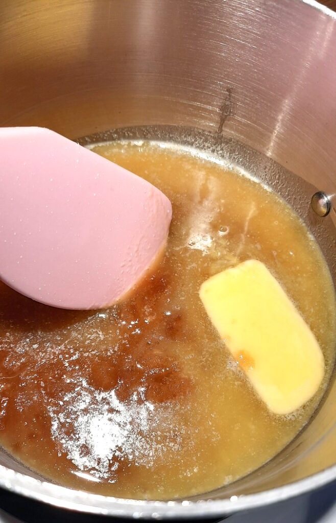 close up of a sauce pan with melting butter and brown sugar in it