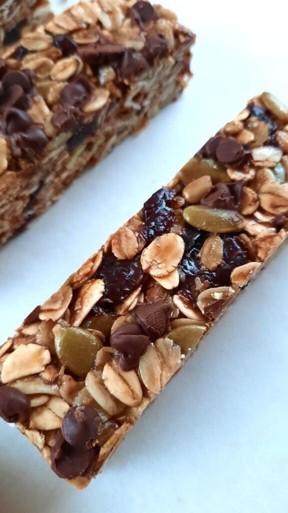 close up image of chocolate and cherry granola bars with pumpkin seeds