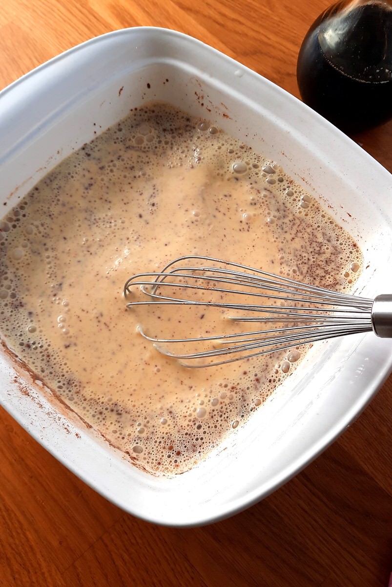 egg and milk mixture for french toast in a shallow baking dish