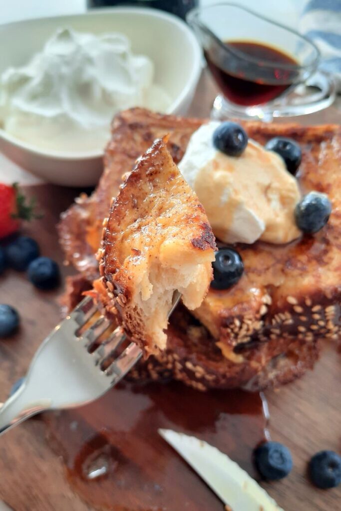 close up of a piece of french toast on a fork