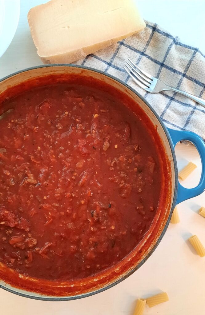 large blue pot of hearty meaty homemade pasta sauce