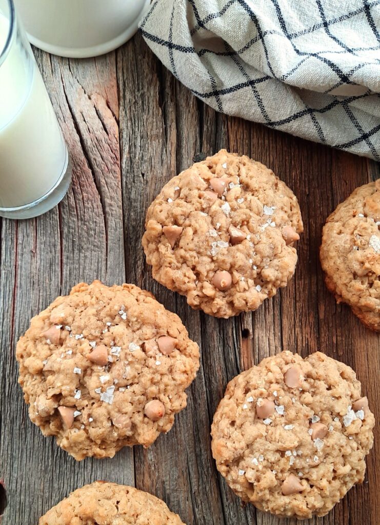oatmeal cookies on a counter with a glass of milk
