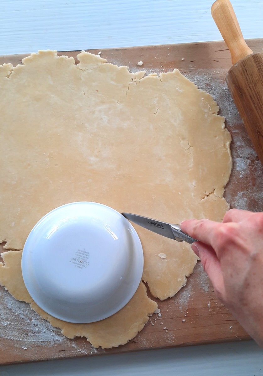 cutting around a circle bowl to create circles in pie dough