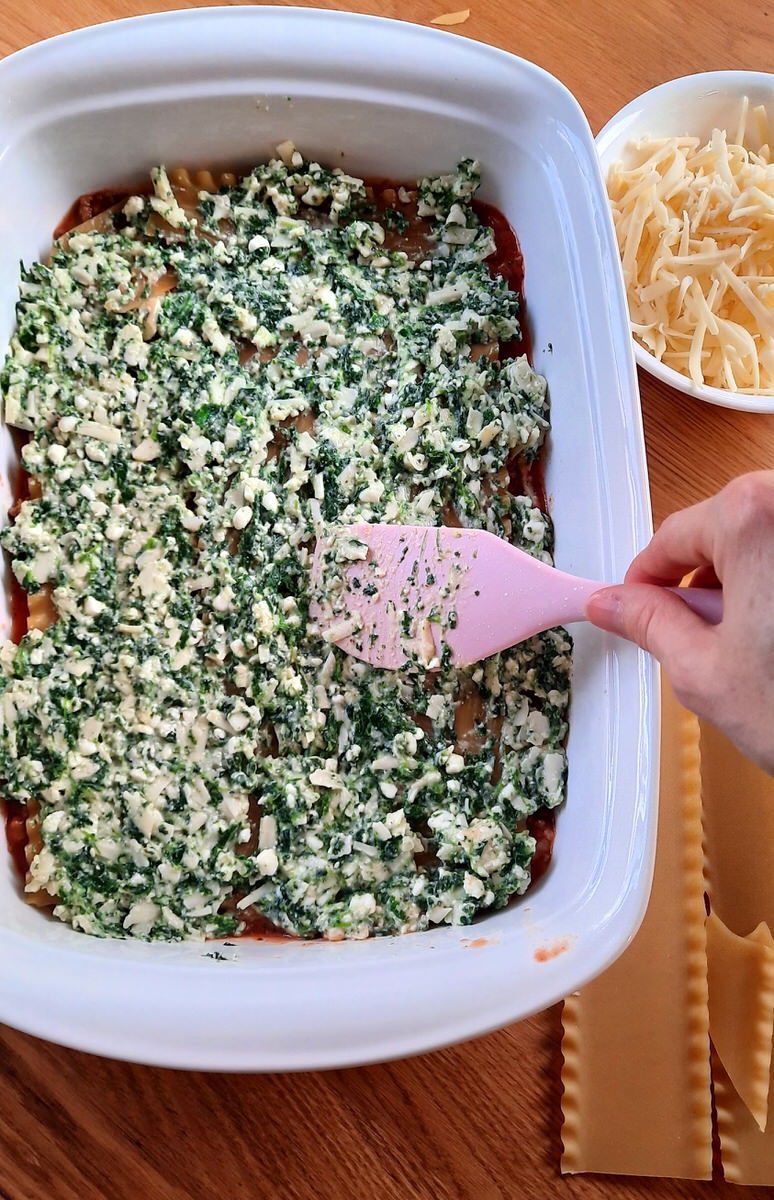 Lasagna showing a layer of spinach and cottage cheese