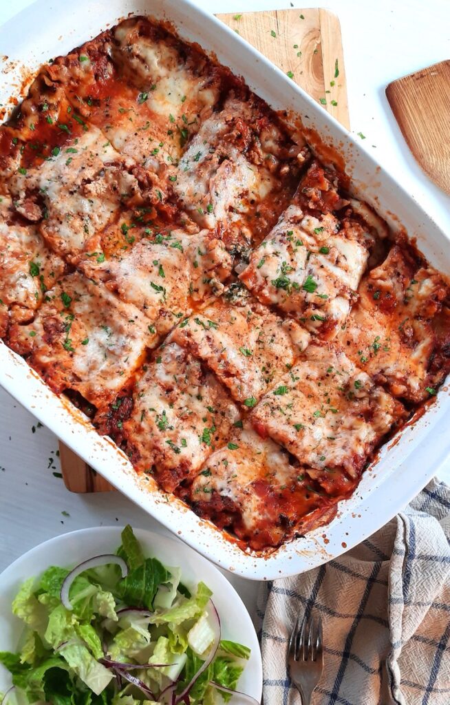 finished homemade lasagna in a white baking dish