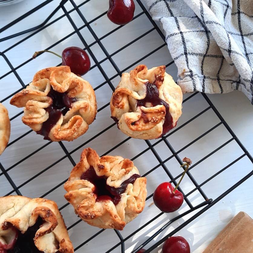 a cooling rack filled with cherry pie rosettes
