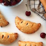 cherry hand pies on a white counter