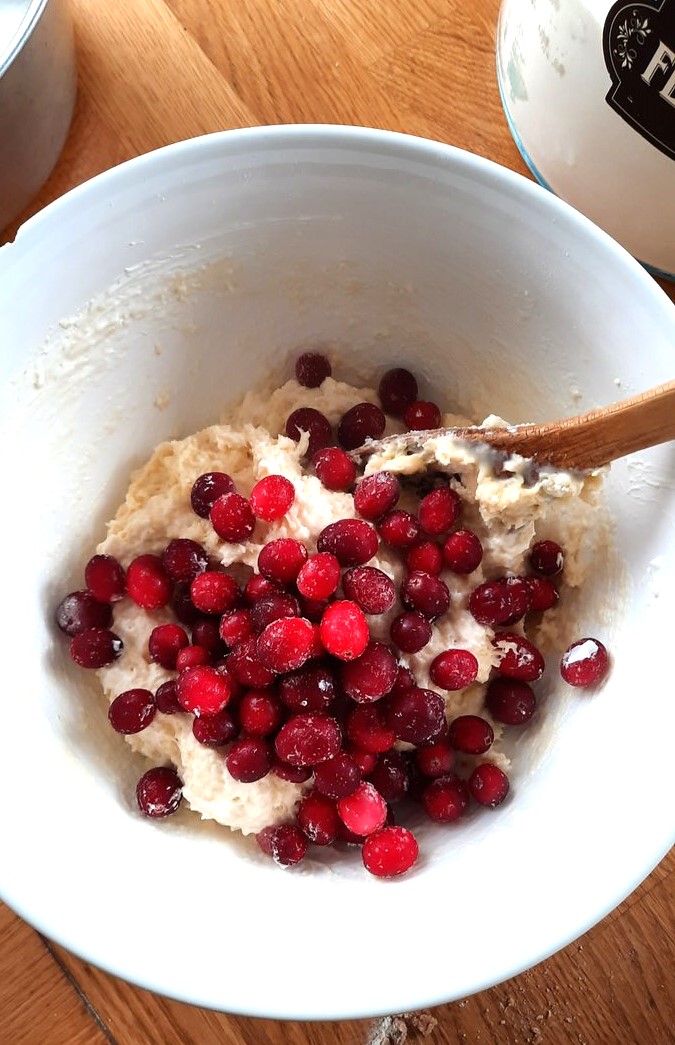 stirring cranberries into coffee cake batter