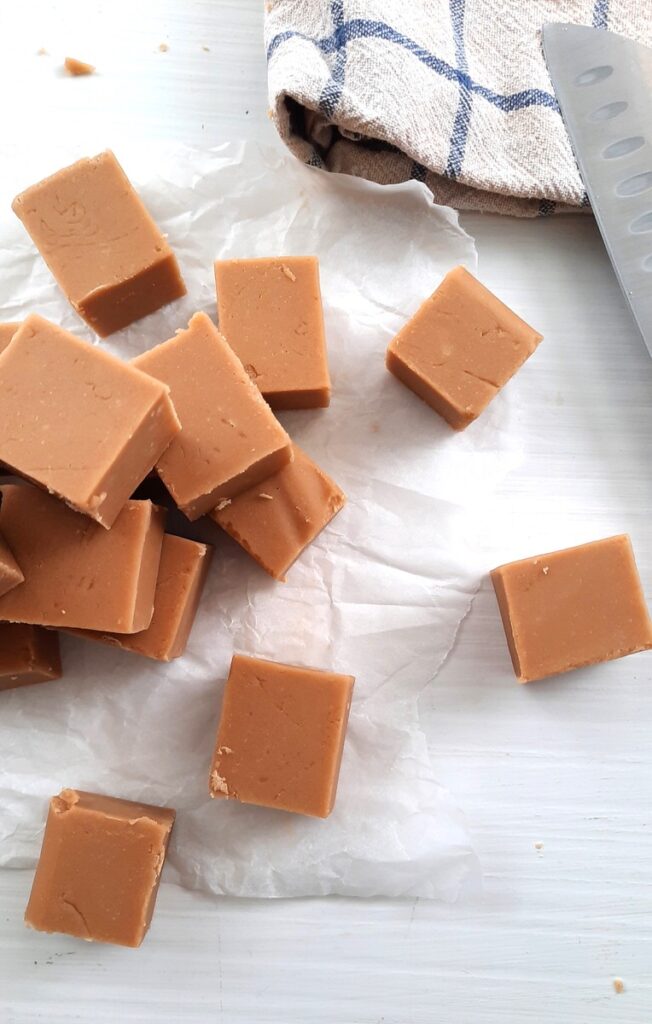 stacks of maple fudge cut into squares on a counter