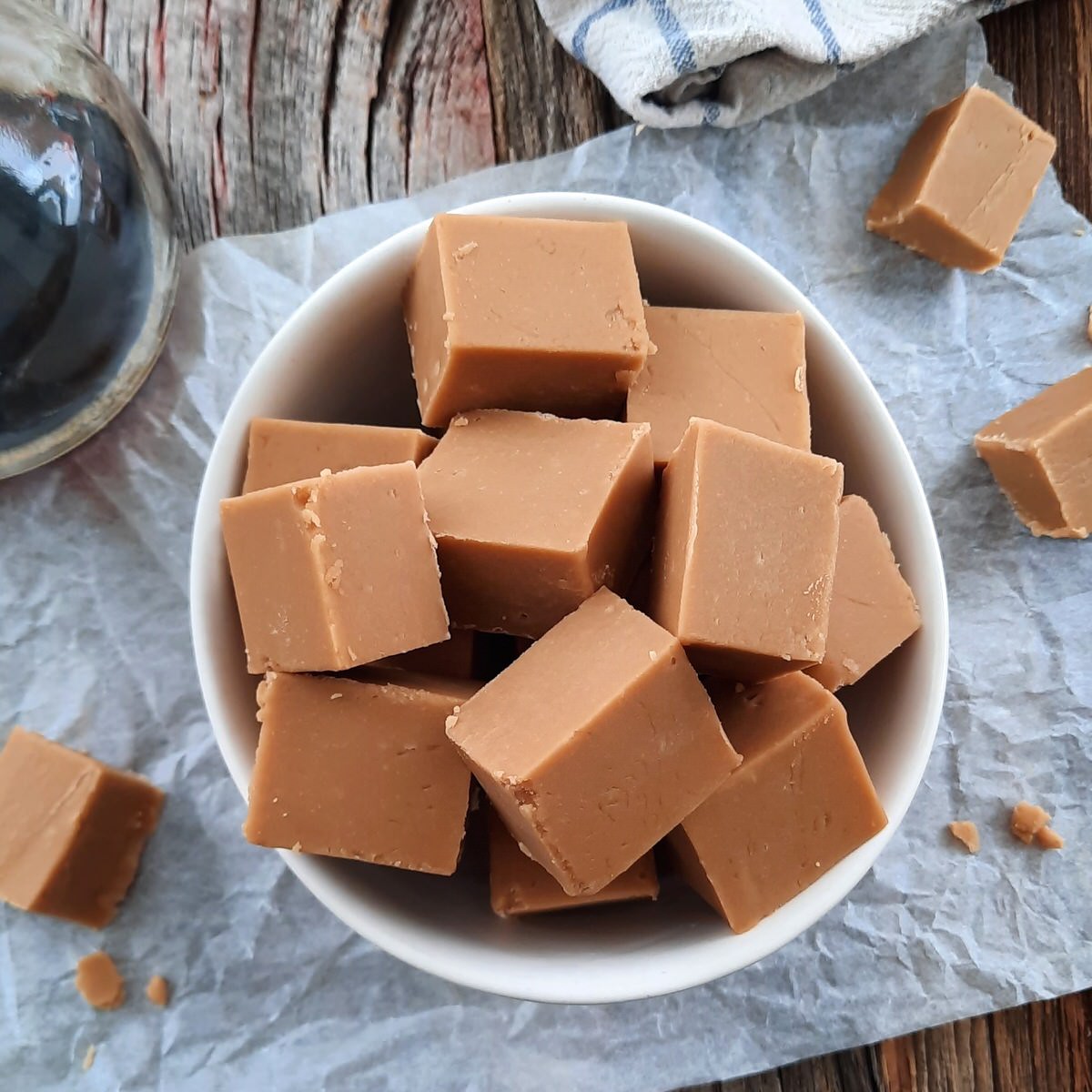 white bowl piled high with squares of easy maple fudge