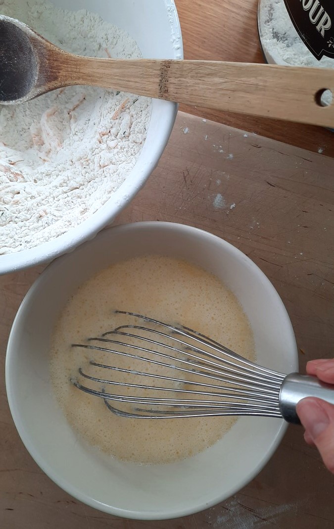 whisking wet ingredients together in a small bowl for irish soda bread