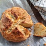 loaf of cheddar irish soda bread with a slice removed