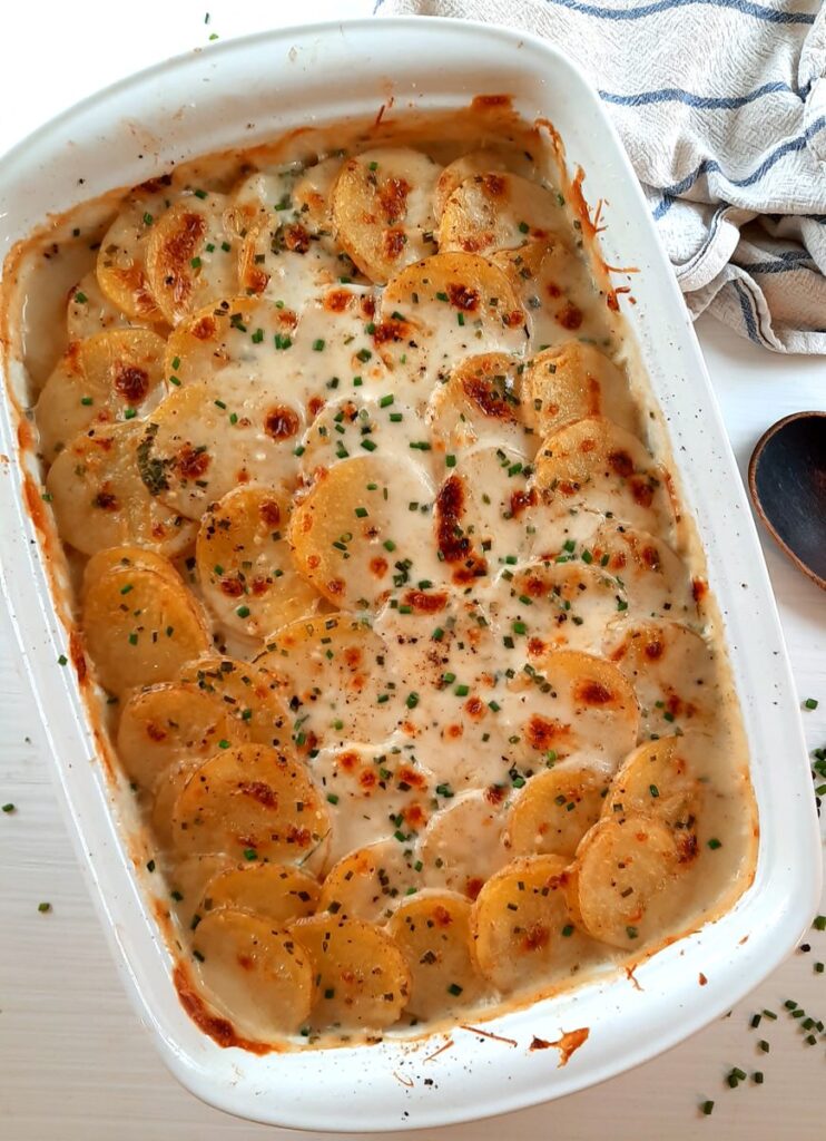 a full dish of bubbly creamy scalloped potatoes for sunday dinner