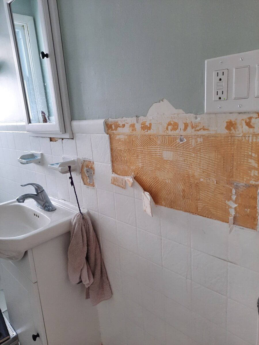broken tiles on the wall of bathroom during reno