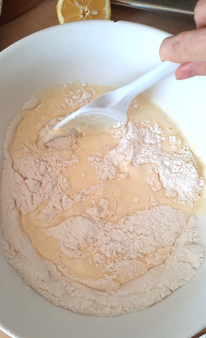 stirring wet ingredients into dry ingredients for lemon blueberry coffee cake