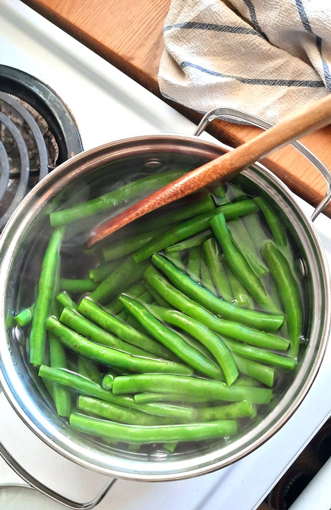 stirring a pot of green beans in